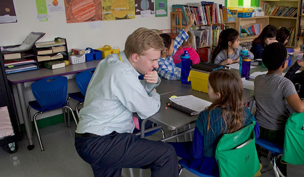 A  student in an elementary school classroom getting hands-on experience.