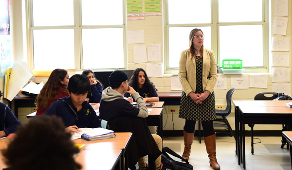 A  student gaining hands-on experience teaching in a high school classroom.