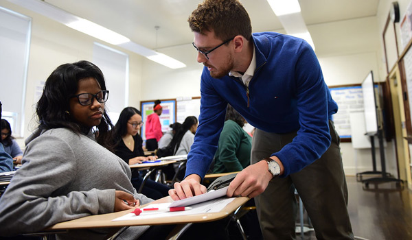 A  student gaining hands-on experience teaching in a high school classroom.